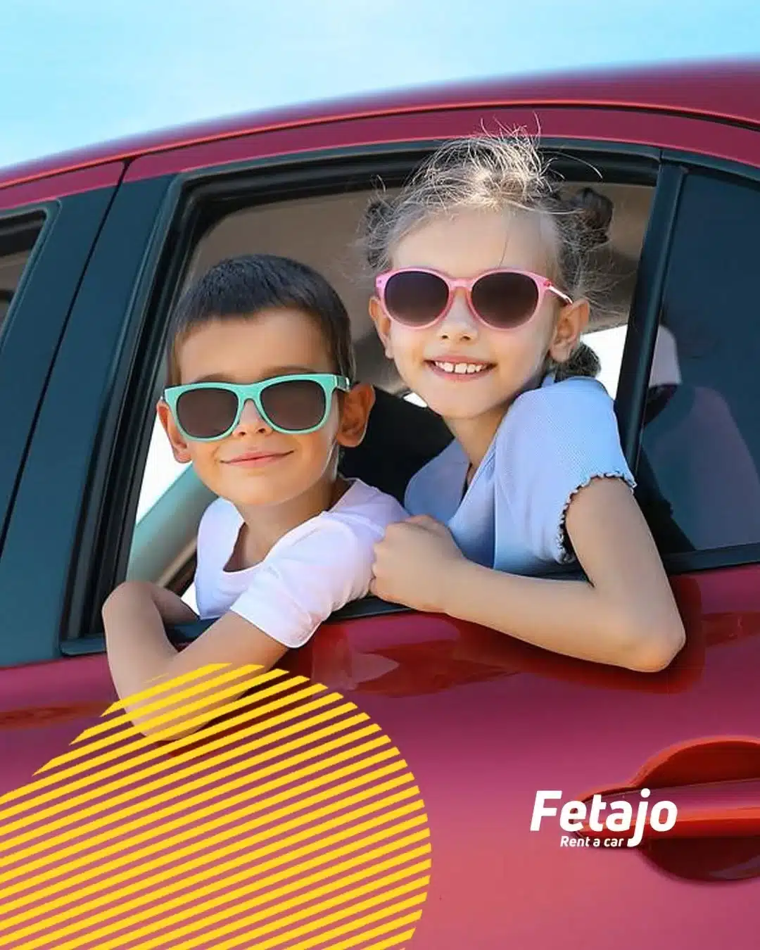 Two happy children with colourful sunglasses leaning out of a Fetajo family car rental Málaga vehicle on a summer road trip