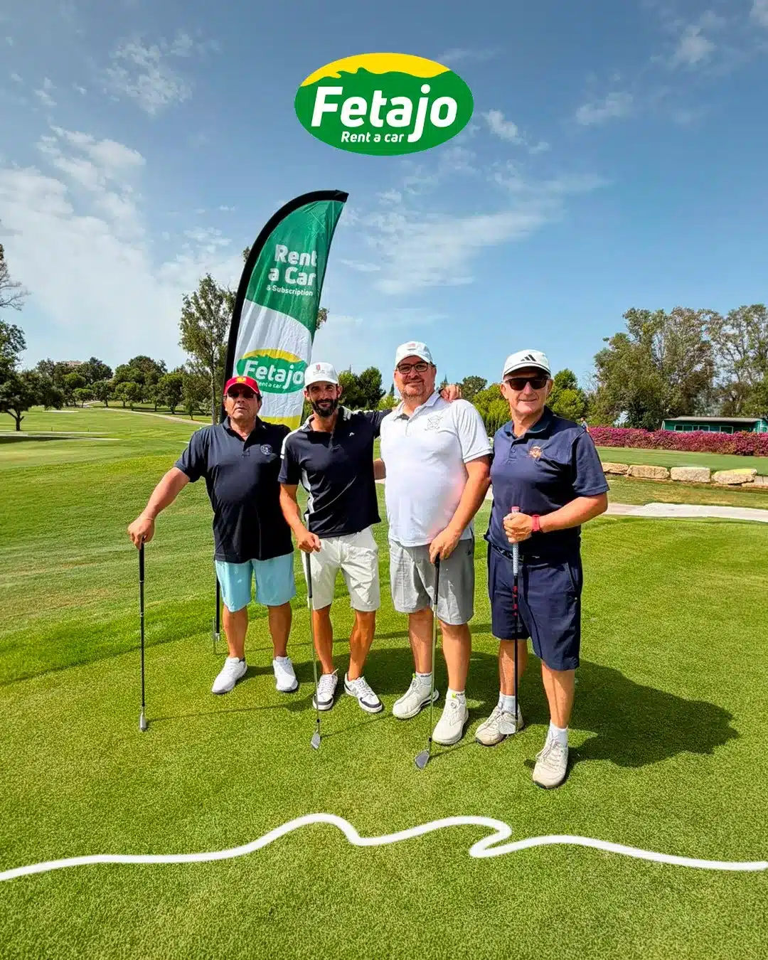 Four players posing with a Fetajo Rent a Car banner on the tee at Atalaya Golf during the WAGC Andalucía qualifier