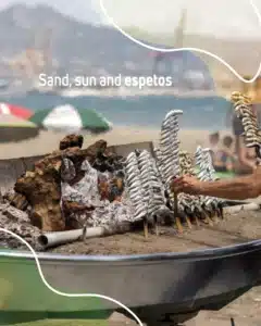 Espetos of sardines grilling over embers on the sand, a first stop when you explore Málaga by rental car